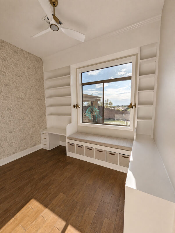 Finished: desk, flanking shelf towers and a cushioned seat, all square to the window