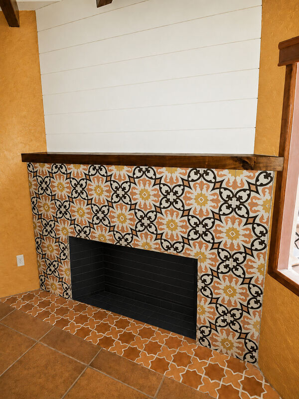 Finished surround in black, ochre and cream encaustic tile