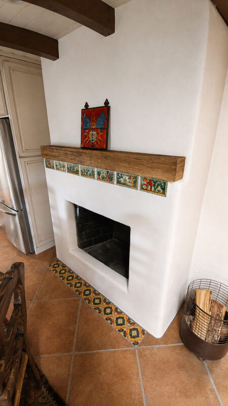 From the side, with a retablo on the mantel