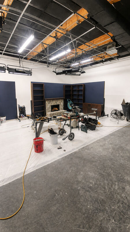 The floor mid-build: flats, bookcases and a stone fireplace, all in pieces