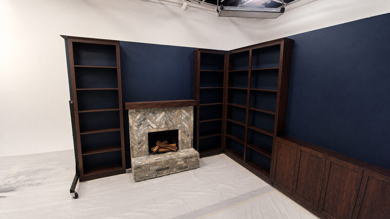 The backdrop itself: walnut bookcases over a cabinet run