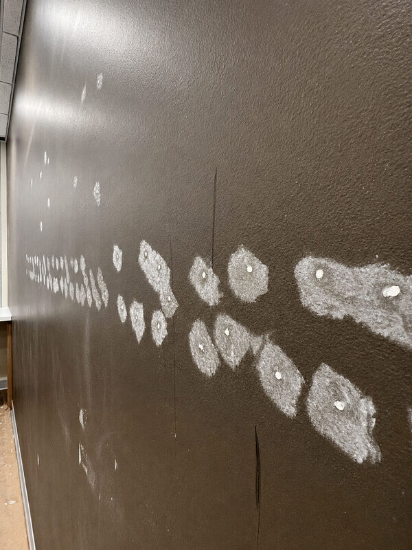 A diagonal run of patched anchor holes